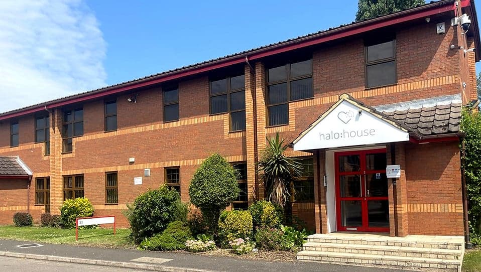 Win At Exams HQ - Halo House building with brick exterior, red doors, and halo:house signage